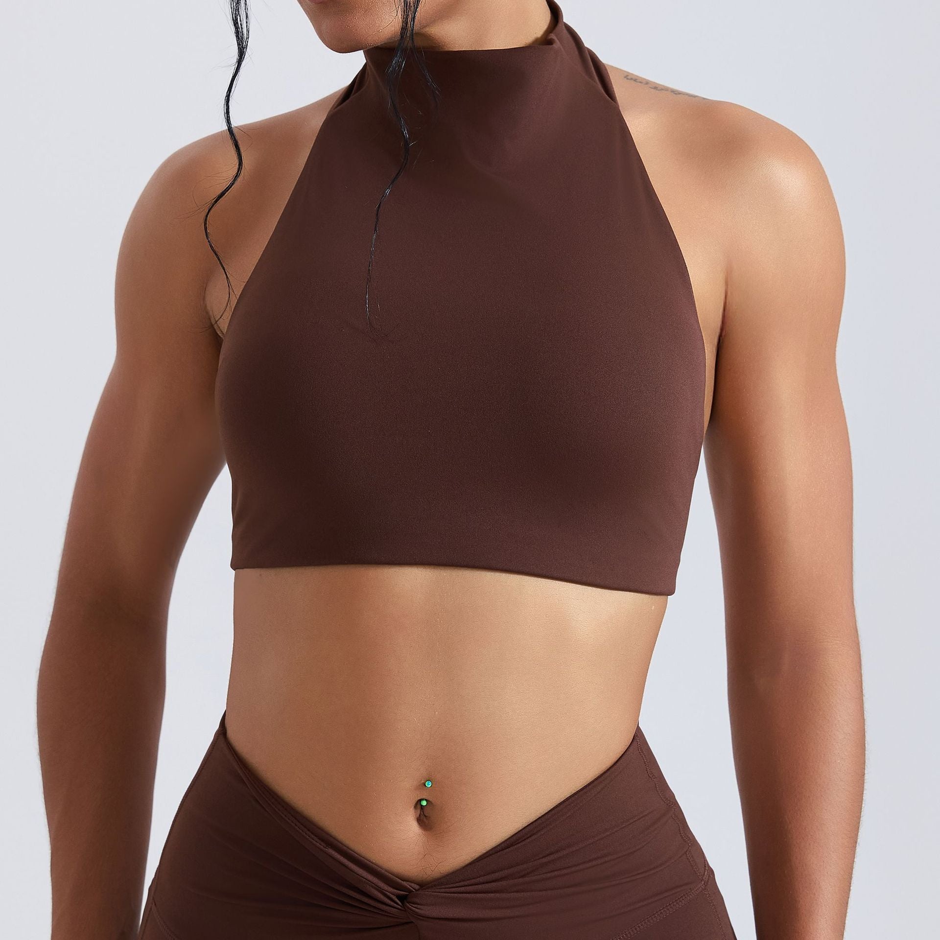 Brown halter top worn by a person on a light gray background